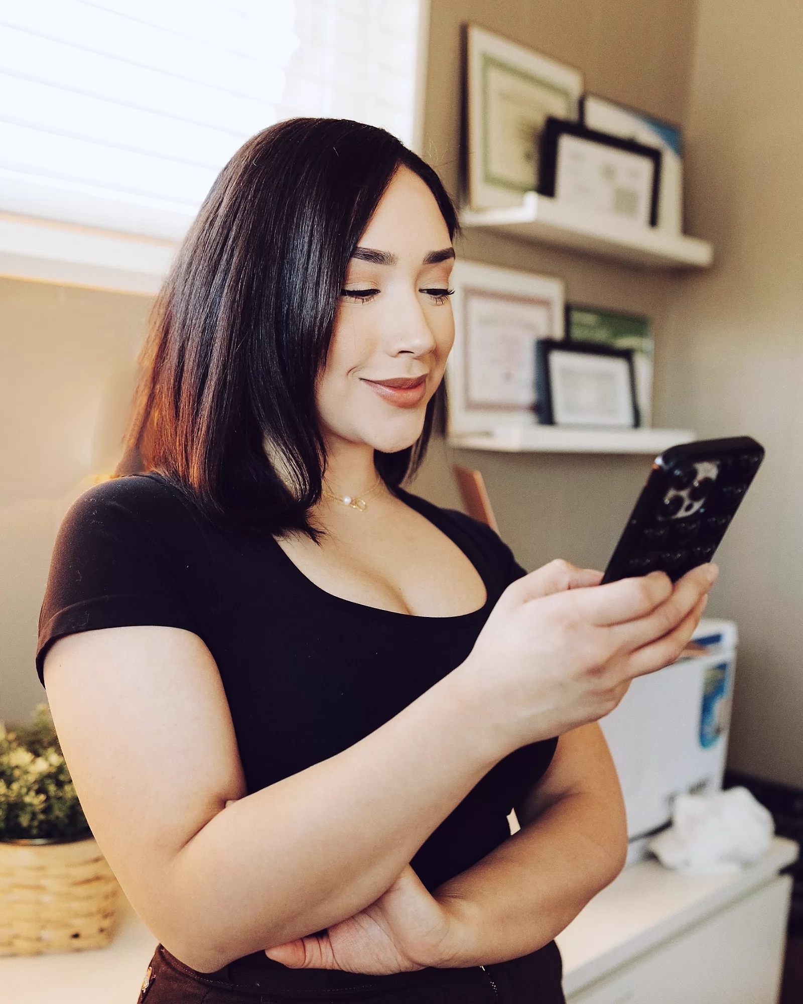 A salon owner checking her bookings on her phone